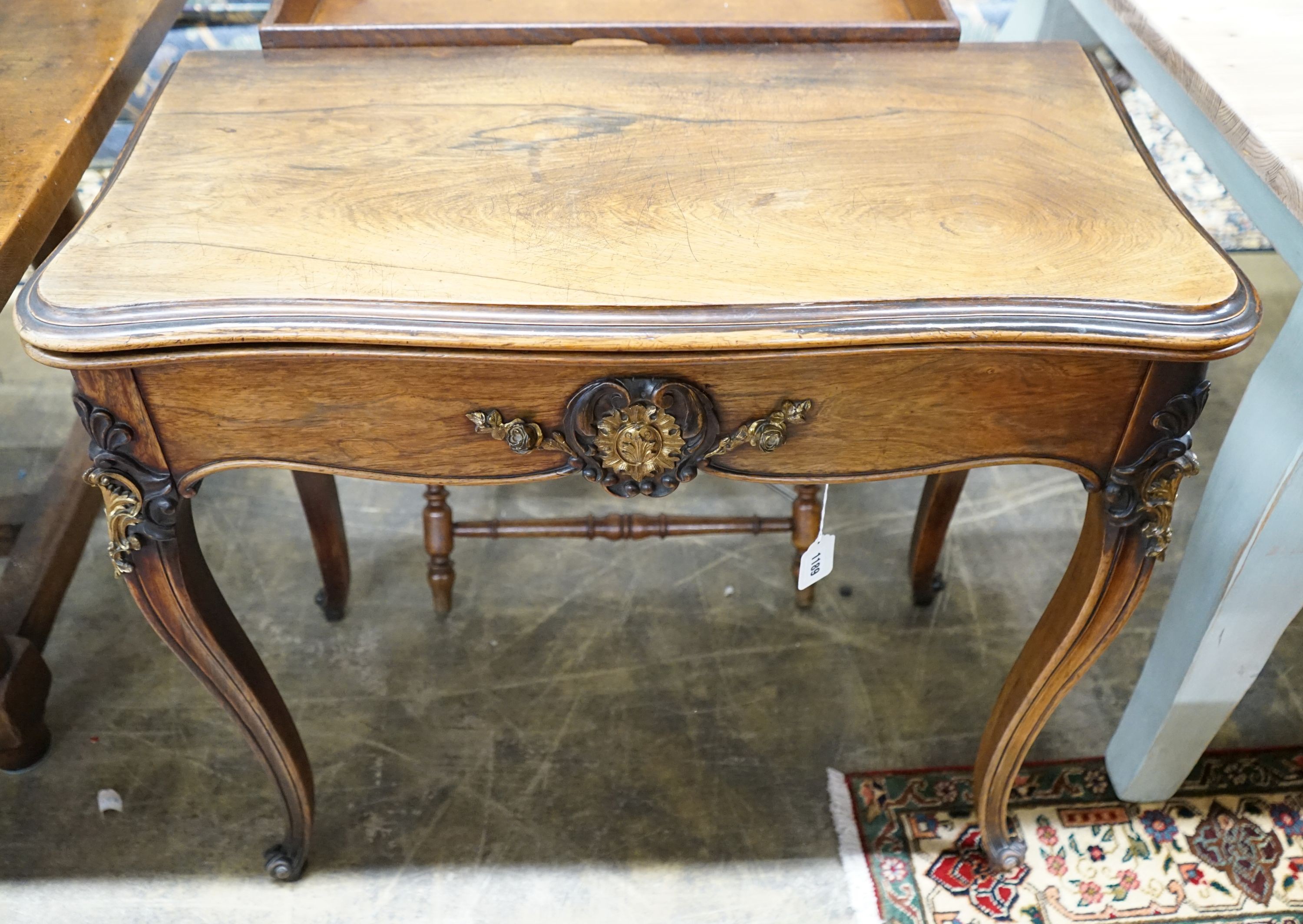 A 19th century French gilt metal mounted rosewood serpentine folding card table, width 82cm, depth 41cm, height 76cm